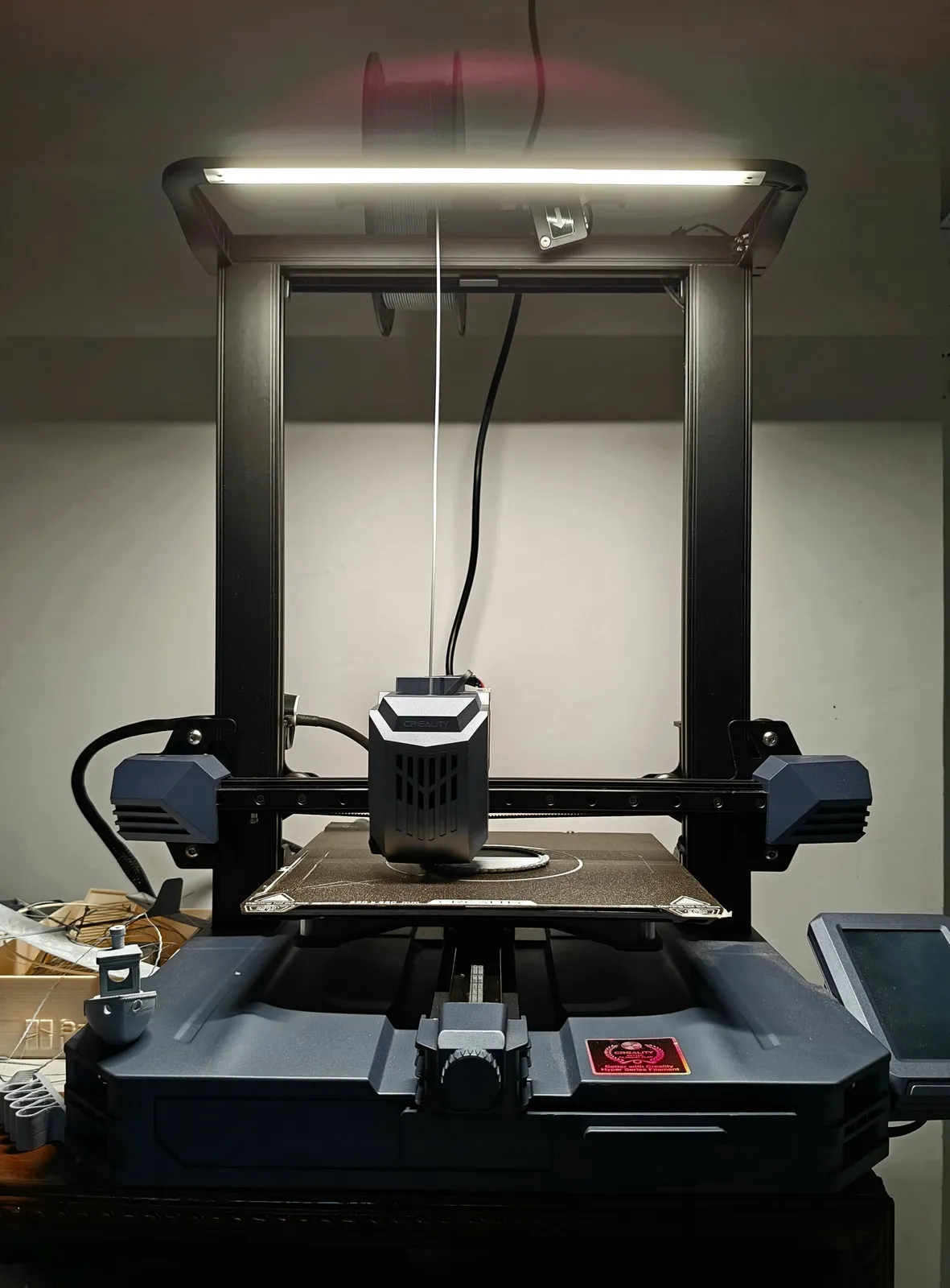 The studio printer part-way through a job, filament feeding into the hot end